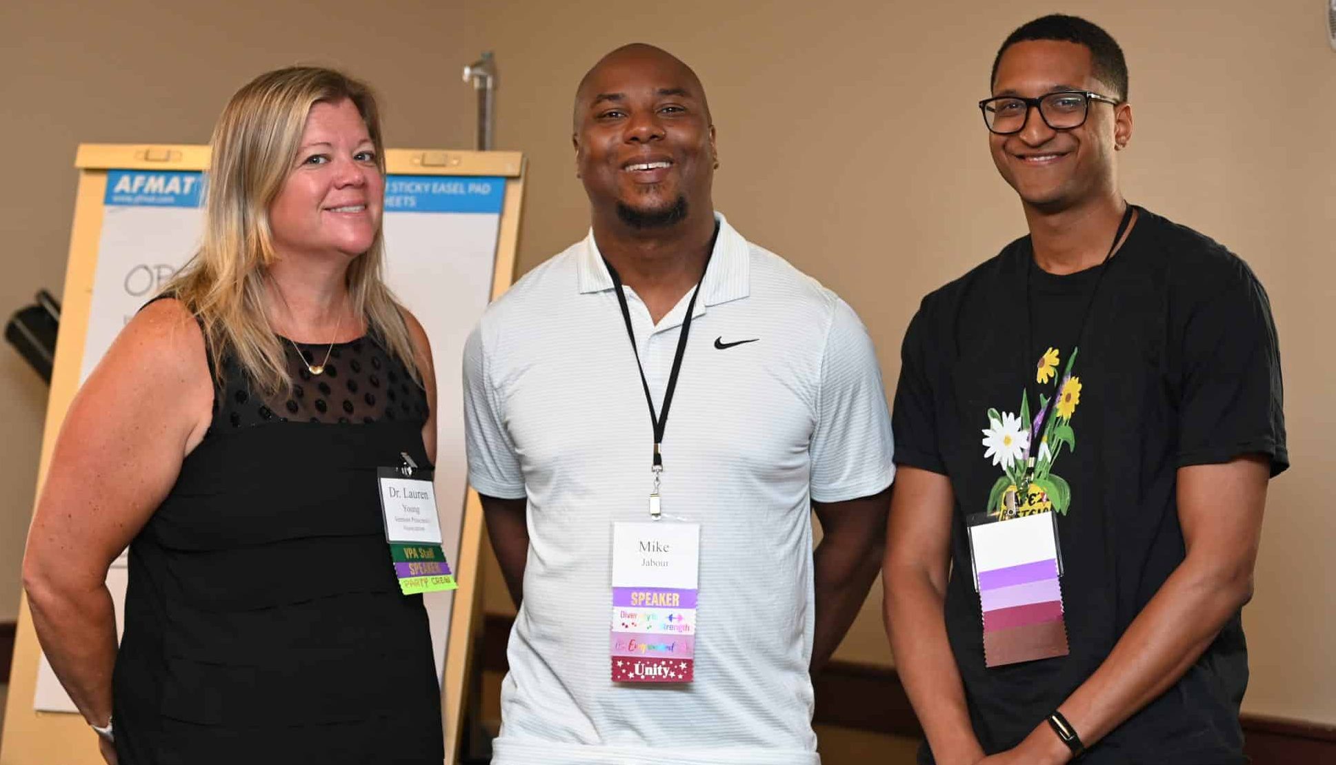 image of three speakers standing together, mike, lauren and Q