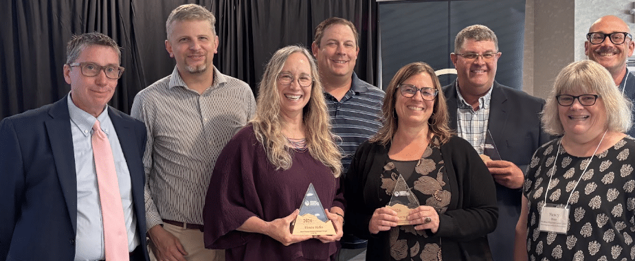 picture of adults standing together at awards ceremony